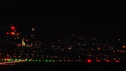 A Passenger Plane Lands on an Airport Runway at Night