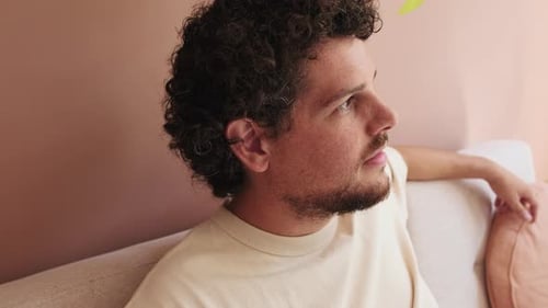 Close up, guy relaxing sitting on the sofa in cozy living room