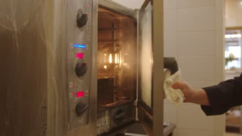 Chef Opening Hot Professional Steaming Oven Door