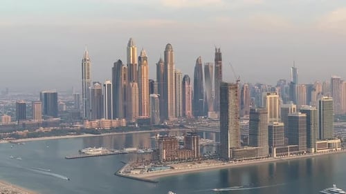 Dubai Marina's skyscrapers framing the skyline, with boats gracefully navigating the waters