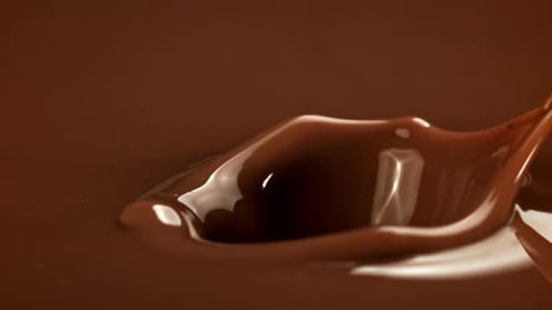 Chocolate Cube Falls Into Melted Chocolate Causing Splash