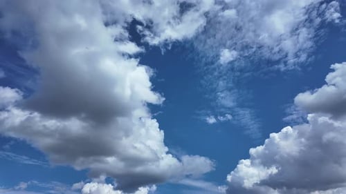 Scenic Puffy White Clouds Against Vibrant Blue Sky