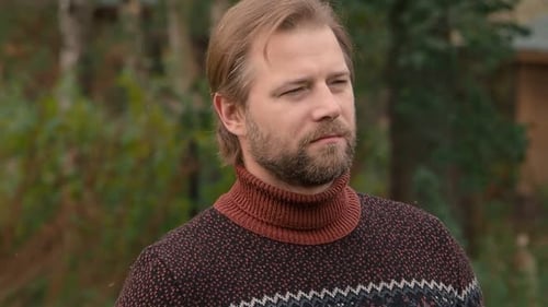 Man in Sweater Standing in Green Wooded Area