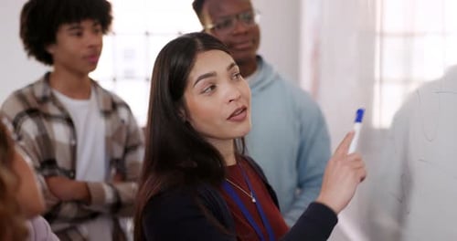 Teacher Explains Lesson to Class in Classroom