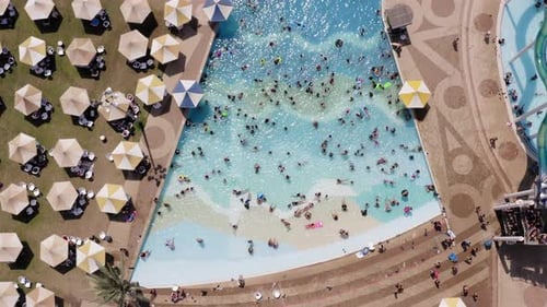 Top down aerial footage of People in a Wave pool.