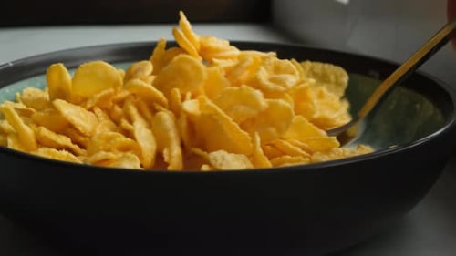 Adding Milk to Cereal Breakfast in a Bowl