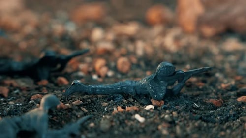 Burning toy soldiers melting on hot ground