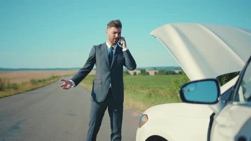 Worried Businessman Standing Speak on Phone Near the Broken Car Opened the Hood Road Help Repair