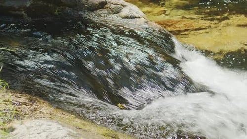 Pure, sparkling, bubbling and cascading water of nearby stream close up.