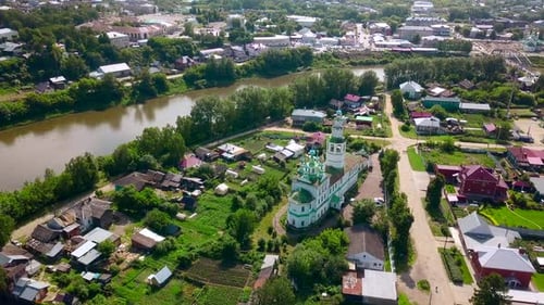 Top view of beautiful church in town by river in summer