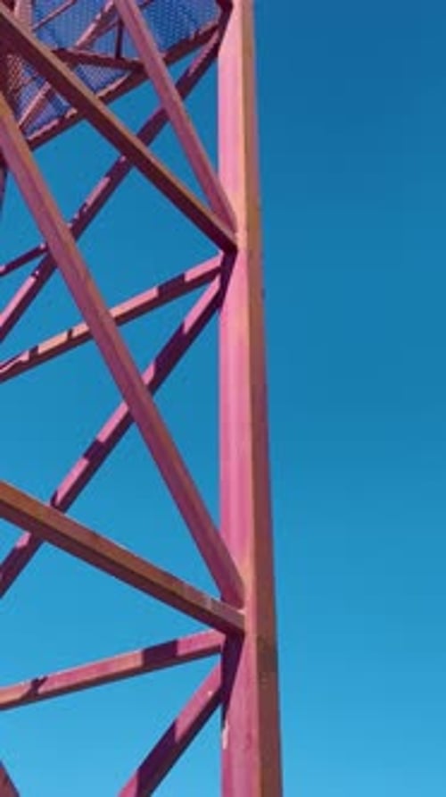 Vertical Video Aerial Footage Of Construction Workers Handling Crane Parts With Expertise On A