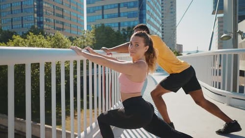 Athletic Couple Stretching Outdoors in Urban Setting