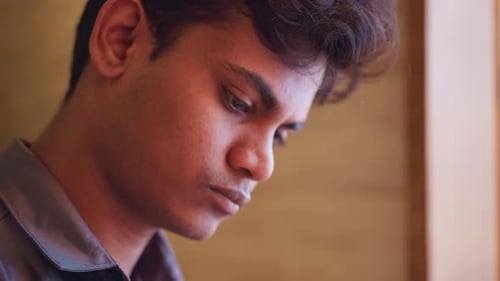 Closeup Profile of Young Man with Serious Expression Mood of Reflection or Focus