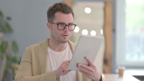 Young Adult Using Tablet Gets Frustrated