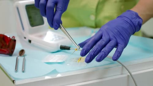 Stomatolog Preparing Dentistry Tools on Workplace. Close Up Dentist Hands Preparing Dental