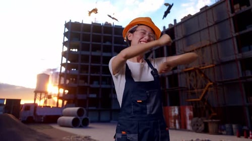 Asian Woman Worker Dancing At Construction Site