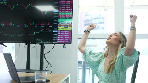 Excited Woman Celebrates Stock Market Success in Office