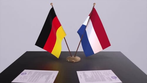 German and Dutch Flags on a Table with Documents