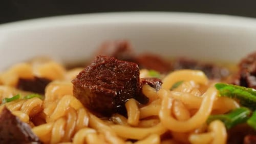 Close-Up of Tasty Noodles with Beef and Herbs