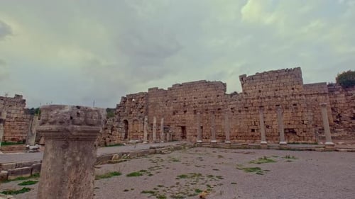 Ancient ruins surrounded by stone walls and columns