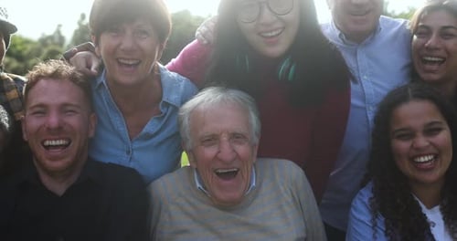 Multigenerational friends embrace joyful unity in city park on sunny day in the USA
