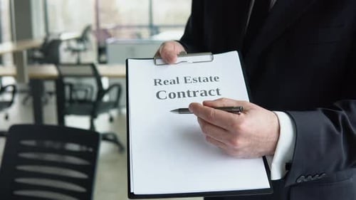 Signing of a Contract Between a Real Estate Agent or Home Developer That Presents a Contract for the