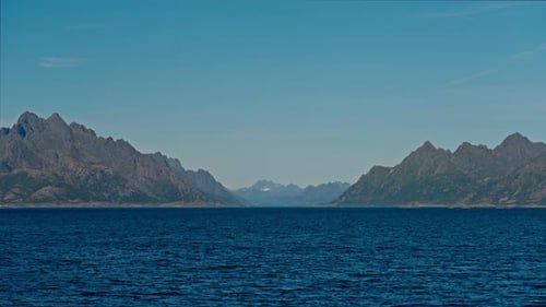Ferry's POV With Blue Sky And Towering Peaks