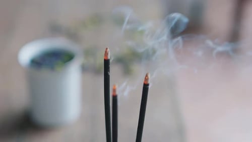 Close Up of Asian Buddhist Smoking Incense Sticks