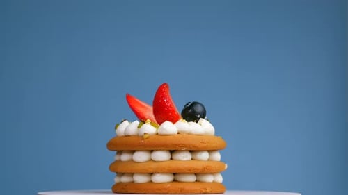 Delicious Cake with Strawberries and Blueberries Spinning