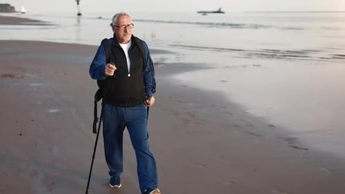 Active Elderly 70s Man Training Walking Stick Contemplating Sea Sunset Landscape Healthy Lifestyle