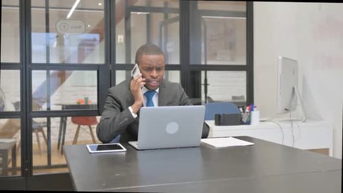 Man in Suit Talking on Phone in Office