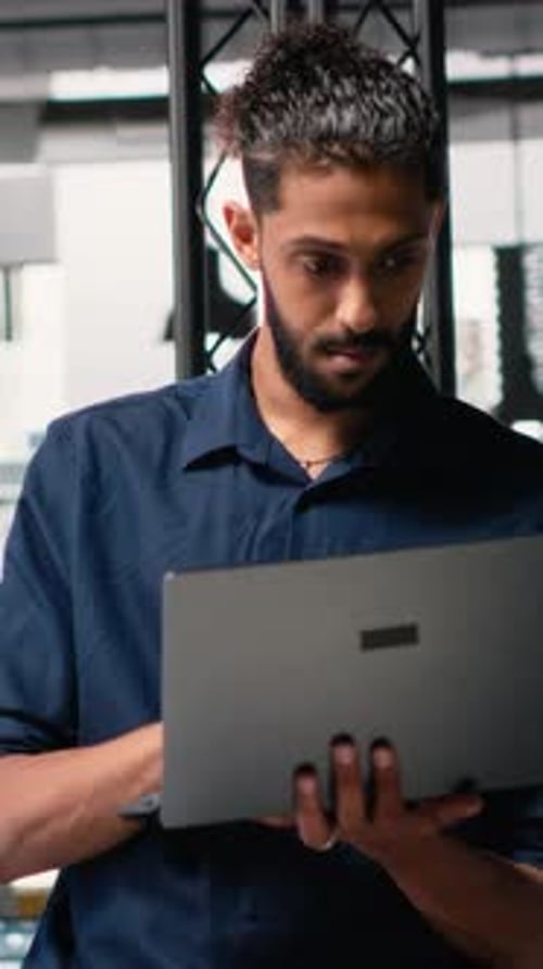 Vertical Video Middle Eastern Contractor Analyzing Architectural 3D Models to Set Measurements