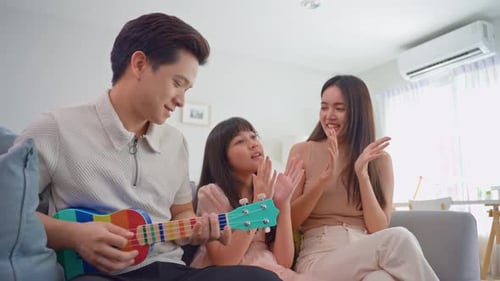 Family Sings Together at Home with Ukulele Music