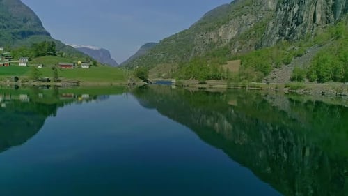 Beautiful reflcetion of the nature in the calm Aurlandsfjord in Norway. Backwards drone dolley shot