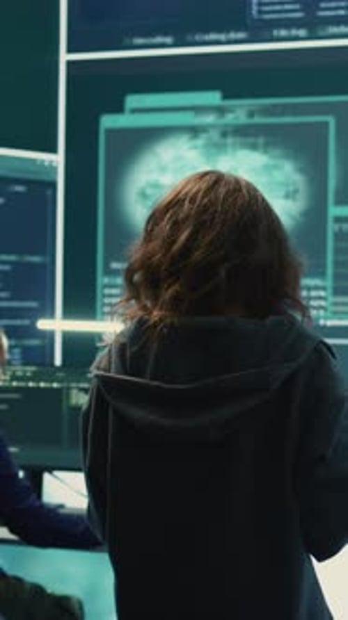 Woman Analyzing Code in Dark Tech Office