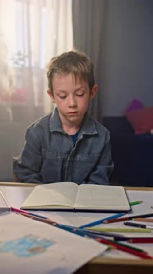 A Child Frozen From Studying Falls on Desk with Books and Notebooks Falls Asleep