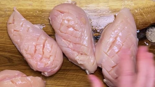 Preparing Healthy Chicken Breast on Cutting Board