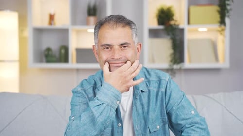 Man looking at camera with a negative expression.
