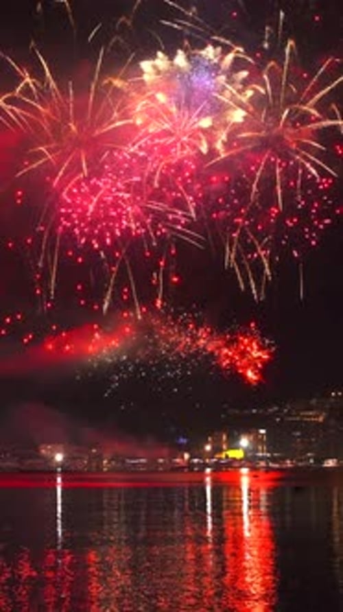 Fireworks with colorful lights over sea