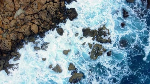 Flying Over Ocean Coastline Cliffside with Blue Pure Water Sea Waves Washes the Rocky Shore Above