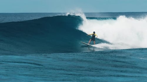Professional Surfer Rides Big Ocean Wave in the Maldives