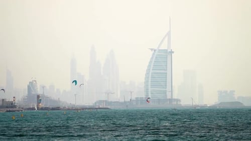 The iconic Dubai Skyline forms the backdrop for kite surfers at Fazza beach.