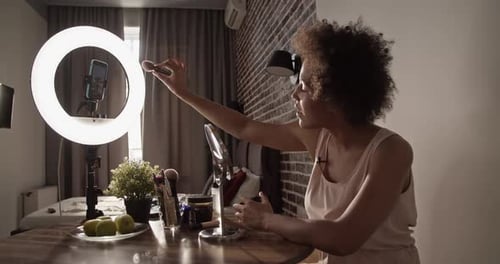 Black Woman Applying Makeup During Live Stream