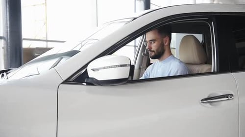 Man Sitting in Driver's Seat of a Car