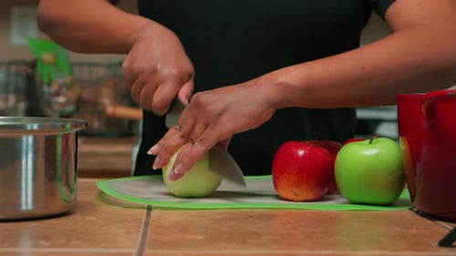Person Cutting Apples on a Cutting Board