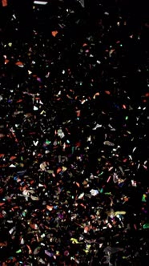 Colorful Confetti Falling on Black Background