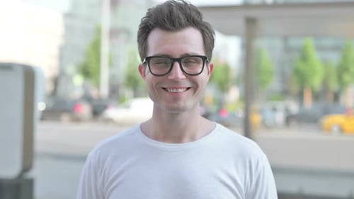 Smiling Man Portrait with Glasses Outdoors in City