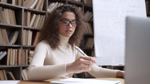 Woman Explaining Equations During Online Tutoring Session