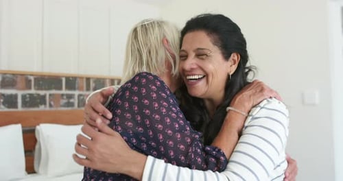 Two Friends Embracing and Laughing Inside