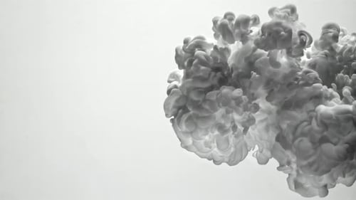 Wispy grey cloud of ink billowing on white background